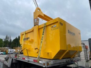 Bigfoot Crane Company A-600D Self-Dumping Bin by Boscaro on the back on a truck