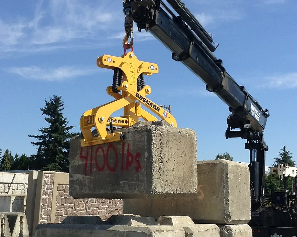 Jersey Barrier Grab by Boscaro lifting precast concrete blocks, designed for highway barriers, available at Bigfoot Crane Company.